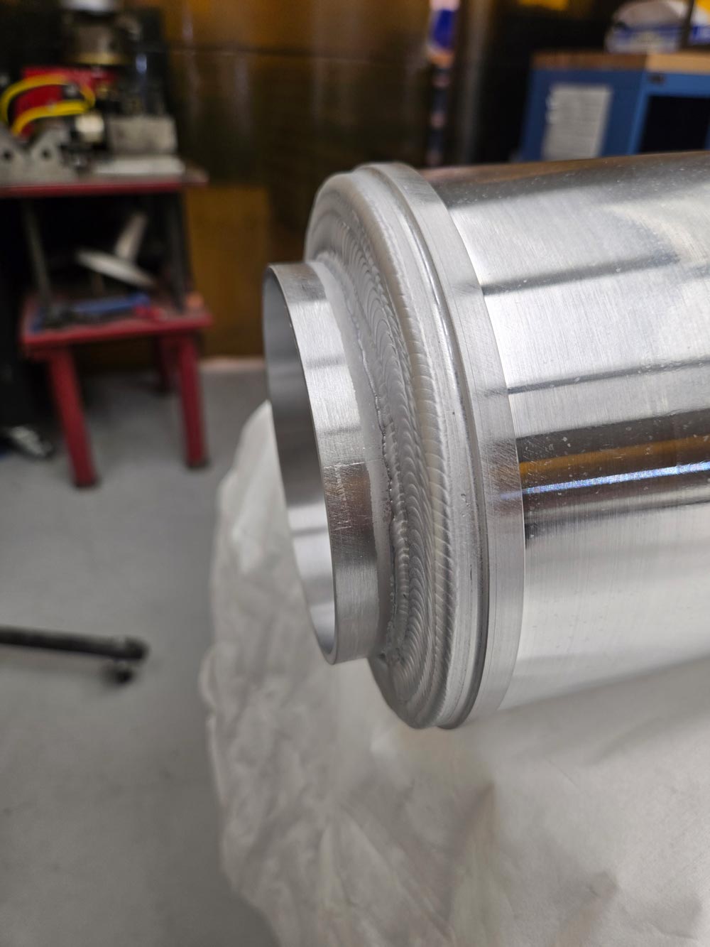 A detail of welding on the VENUS plasma chamber. Credit: Kris Pearson, Berkeley Lab