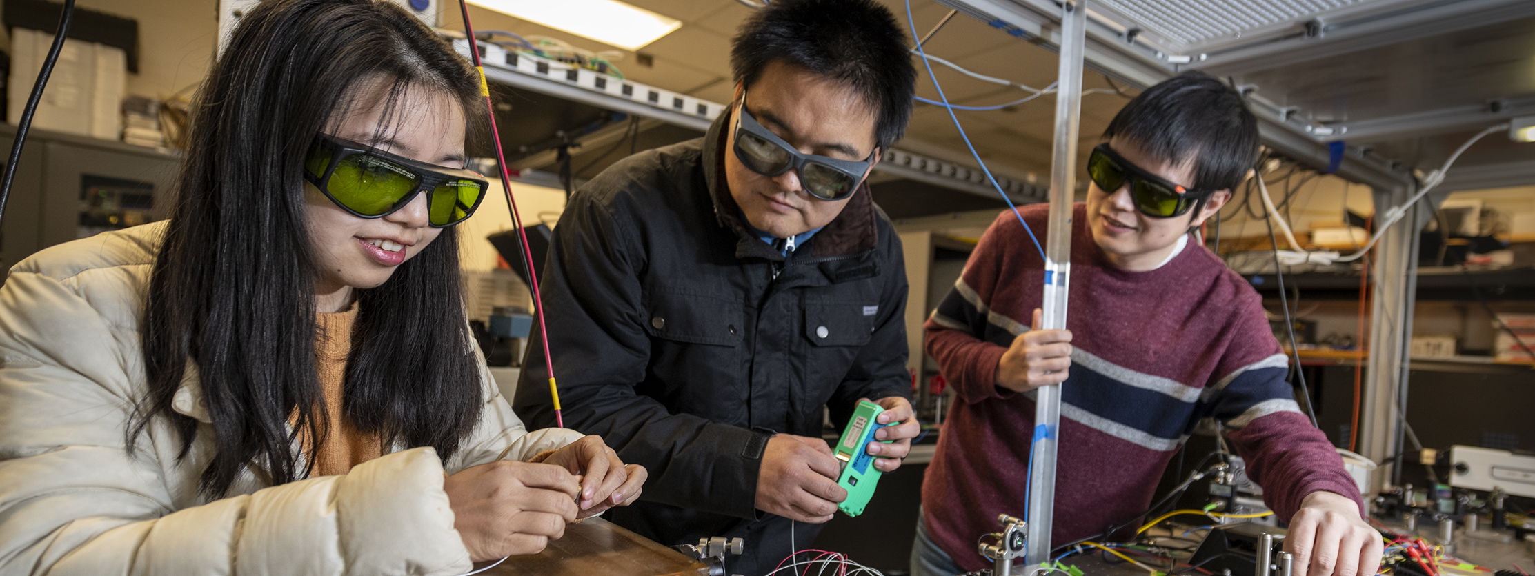Scientists make adjustments to the optics of a laser in the Berkeley Accelerator Controls and Instrumentation Program Laser Lab.