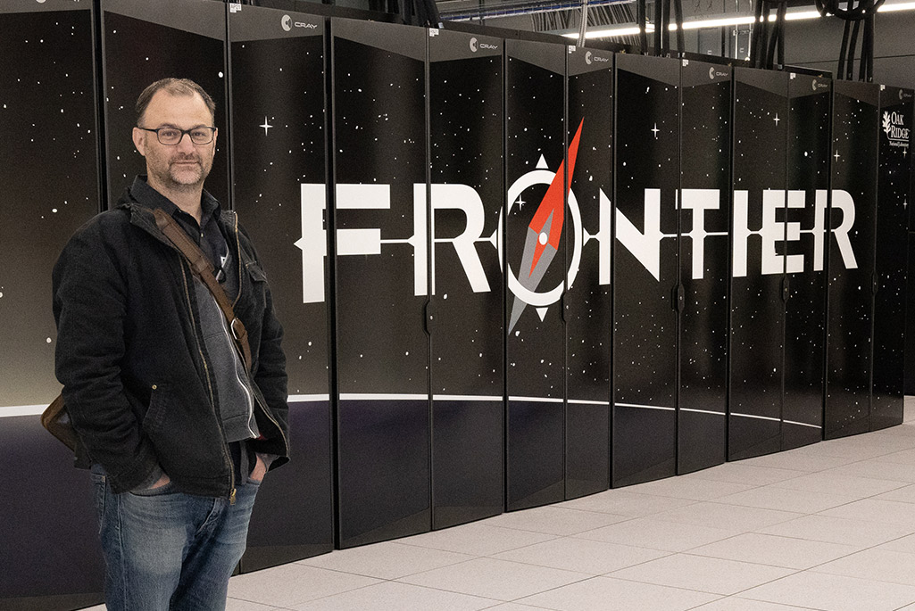 Walker-Lout inspects Frontier, the world’s fastest supercomputer, where many of the lattice QCD calculations may be carried out. Credit: Carol Morgan, ORNL.