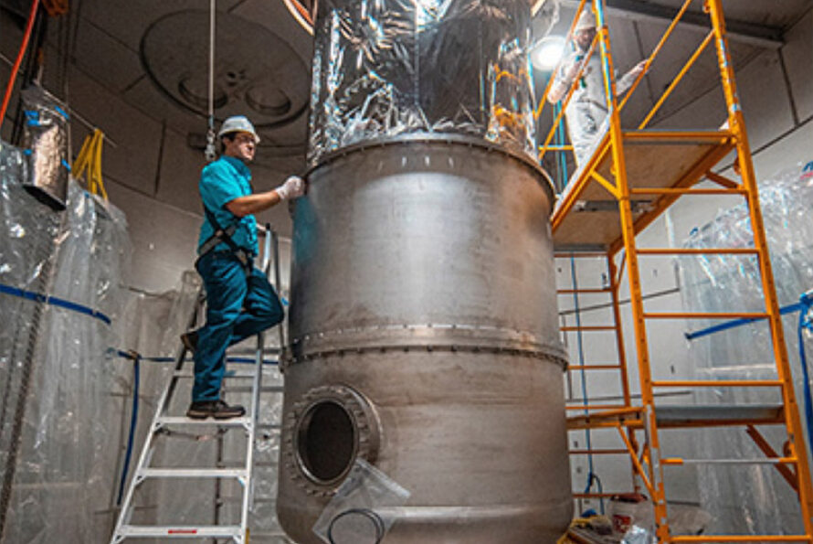 Engineers, Charles Maupin (left) and Jake Davis work to install one of the LUX-ZEPLIN (LZ) chambers. LZ is a next-generation dark matter experiment in South Dakota. Photo Credit: Nick Hubbard