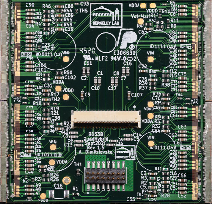 A fully dressed ITkPixV1 Quad Module. 4 chips are connected to 1 sensor tile (4cm by 4cm) onto which a flex PCB is glued to connect to power and data services. (180 degree correction) Credit: Timon Heim, Berkeley Lab