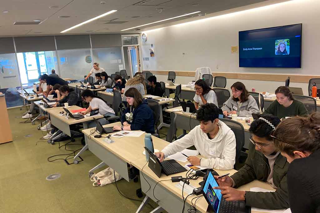 2024 ATLAS Masterclass - Students working on computers at long desks. 