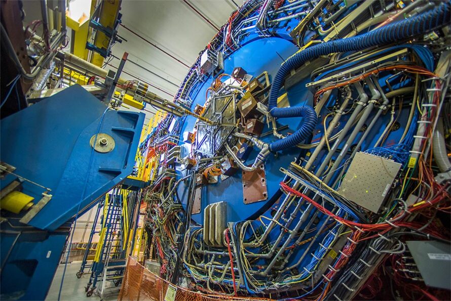 The STAR detector at the U.S. Department of Energy's Brookhaven National Laboratory. (Credit: Brookhaven National Laboratory) Alt text: Pipes and cables on the exterior of the large blue STAR detector.