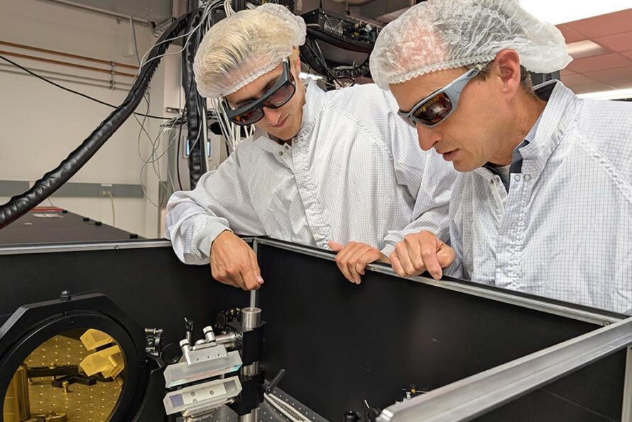 Finn Kohrell and Jeroen van Tilborg discuss the laser's optical stretcher, a part of the laser system that controls the separation (stretching) and re-compression of different wavelength components of the laser pulse, which are all crucial for laser amplification and pulse envelope shaping. (Credit: Matthew Fullmer, Berkeley Lab)