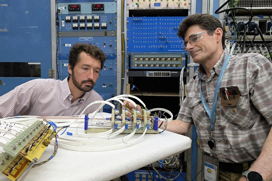 Reed Teyber and Chet Spencer work on the experimental setup for measuring inter-tape contact resistance in REBCO-based superconducting cables. (Credit: Matthew Fullmer, Berkeley Lab)