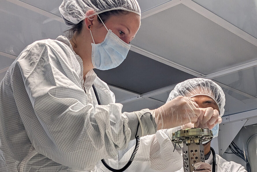 Physics Division staff scientist Aritoki Suzuki (right) and postdoctoral researcher Kaja Rotermund install the central bearing assembly for the shaft that rotates LuSEE-Night’s carousel. This component was later replaced by a shaft made of a glass-reinforced PEI polymer. Credit: Joe Silber, Berkeley Lab
