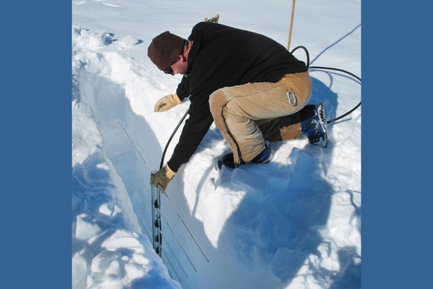 Berkeley Lab Electronics Engineer Thorsten Stezelberger places an antenna in a hole in the Ross Ice Shelf in Antarctica. Credit: Spencer Klein, Berkeley Lab