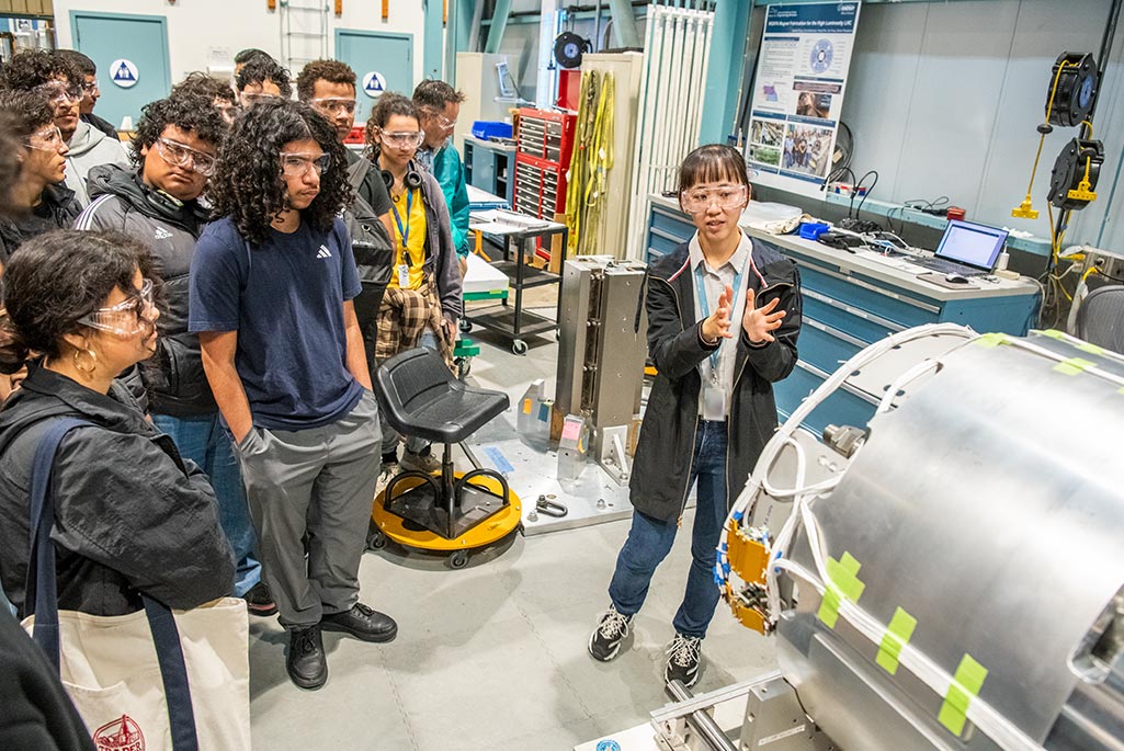 Yufan Yan, a postdoctoral researcher in the ATAP Division, explains how superconducting magnets work at Berkeley Lab's Magnet Test Facility. Credit: Robinson Kuntz, Berkeley Lab