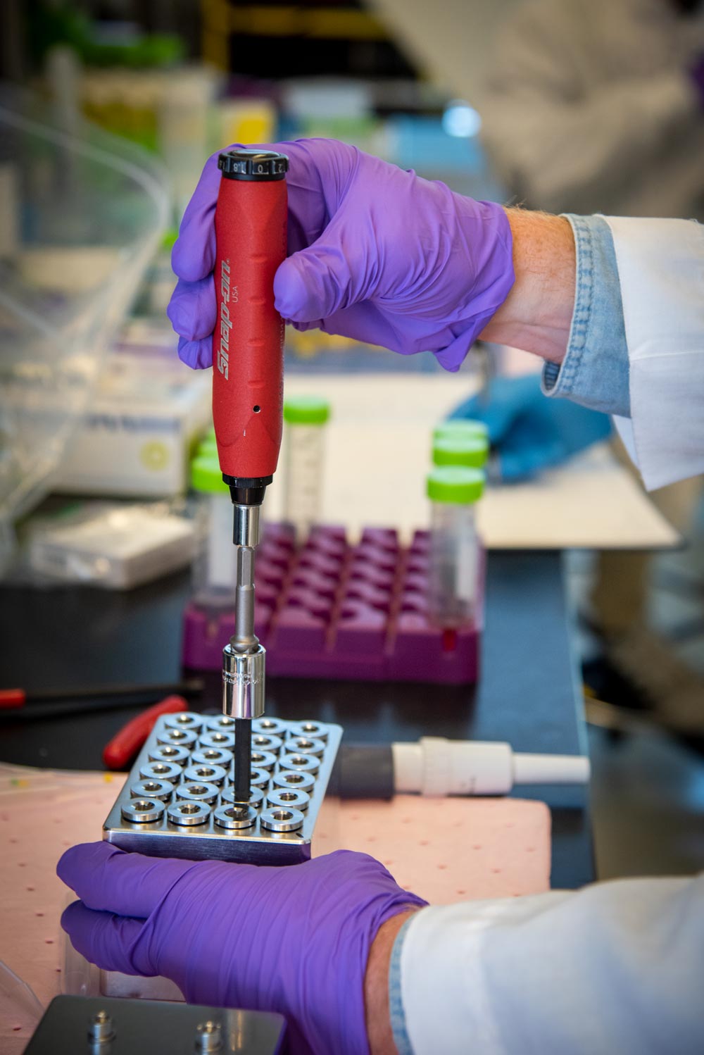 A torque screwdriver is used to control the applied torque and achieve a proper seal for each well. (Credit: Nick Wenner, Berkeley Lab)