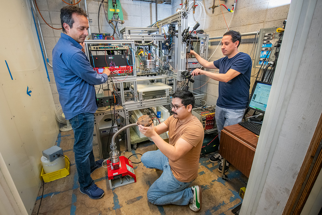 Arun Persaud, head of ATAP’s Fusion Science & Ion Beam Technology Program (left), graduate student Juan Cristhian Luque Gutierrez (center), and research scientist Mauricio Ayllon Unzueta (right) working on INSPECT3R, the “in situ nuclear spectrometer with 3D resolution,” an advanced high-resolution imaging technology that can map the elemental composition of a planet or asteroid’s surface in 3D with centimeter-scale detail. (Credit: Robinson Kunz, Berkeley Lab)