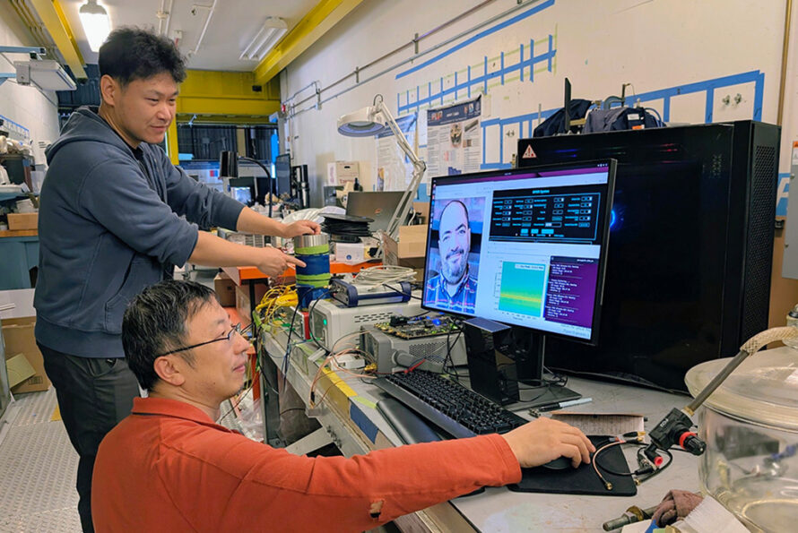 Linqing Luo (top left) and Gang Huang (foreground) work on the optical frequency domain reflectometry system. (Credit: Matthew Fullmer, Berkeley Lab)
