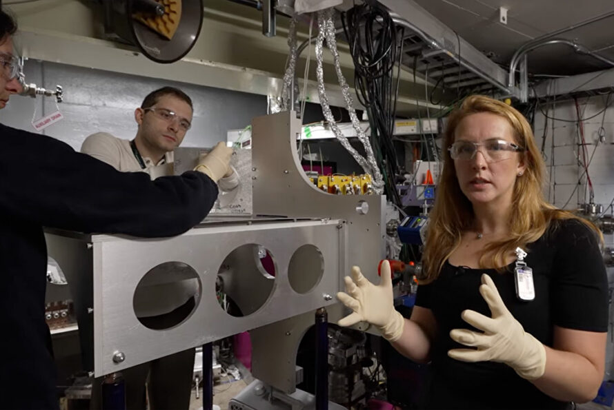 Nuclear Science Division postdoc Marilena Lyklardopoulou (left) and Chemical Sciences Division graduate student Mirza Grebo (center) make adjustments as Jennifer Pore (right foreground), a researcher in Berkeley Lab's Nuclear Science and Chemical Sciences Divisions, shows viewers the FIONA spectrometer at the Lab's 88-Inch Cyclotron.