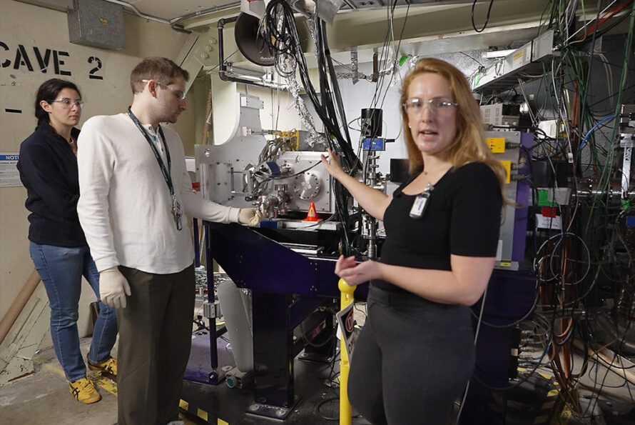 Jennifer Pore (right foreground), a researcher in Berkeley Lab's Chemical Sciences and Nuclear Science Divisions, shows viewers the FIONA spectrometer at the Lab's 88-Inch Cyclotron.