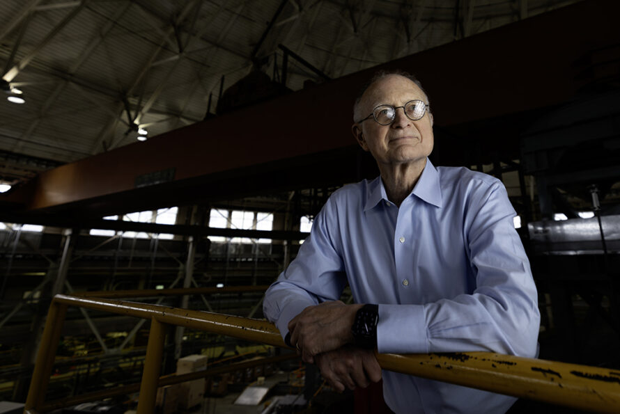 Photo of Mike Witherell leaning on a railing at the ALS. (Credit: Christopher Michel for the National Academy of Sciences)