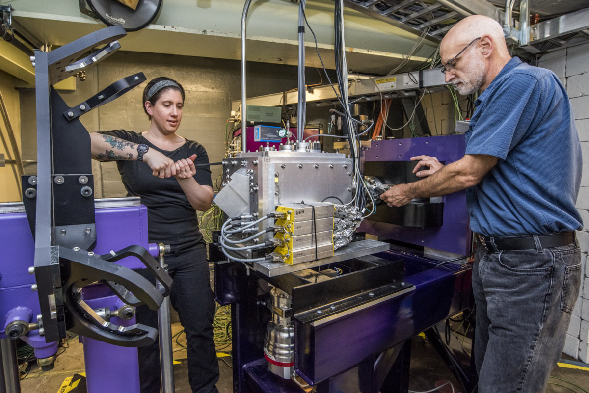 Berkeley Lab Scientists Jacklyn Gates, left, and Kenneth Gregorich work on FIONA, a new device at the Lab’s 88-Inch Cyclotron. FIONA is designed precisely measure the mass number of the periodic table’s superheavy elements, and could also be useful for other types of explorations of superheavy elements. (Credit: Marilyn Chung, Berkeley Lab)