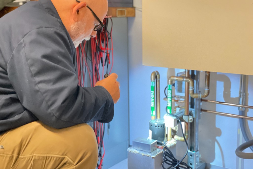 Tom Lipton, an Engineering Technical Manager in the Engineering Division, performs a water inspection in building 50B on the Berkeley Lab campus. (Credit: Allison Barker, Berkeley Lab)