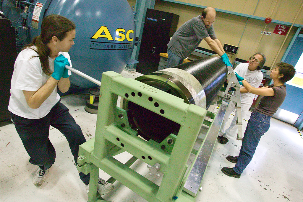 Tom Johnson (left) and other members of Berkeley Lab's ATLAS project engineering team assemble the carbon fiber support tube for the ATLAS Pixel Detector (April 2004). Credit: Roy Kaltschmidt, Berkeley Lab