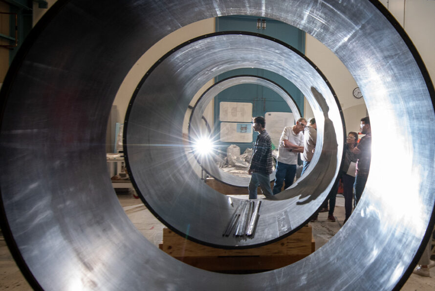 The members of the ATLAS group at Berkeley Lab photographed around the ATLAS ITk Outer Cylinders being assembled at Berkeley Lab (October 2023). Credit: Thor Swift, Berkeley Lab