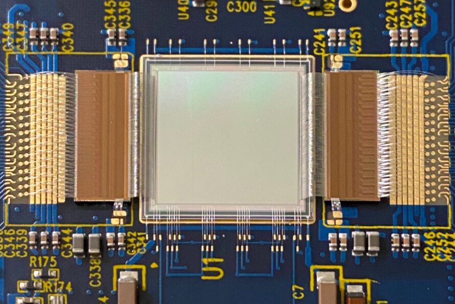 An image sensor and two custom readout chips for the VeryFastCCD project. These components were designed at Berkeley Lab and wire bonded together in the Engineering Division. The unusual design of these pieces means that the sensor is wire bonded directly to the readout chips on both sides rather than the more traditional method of being bonded to the printed circuit board. (Credit: Phathakone Sanethavong, Berkeley Lab)