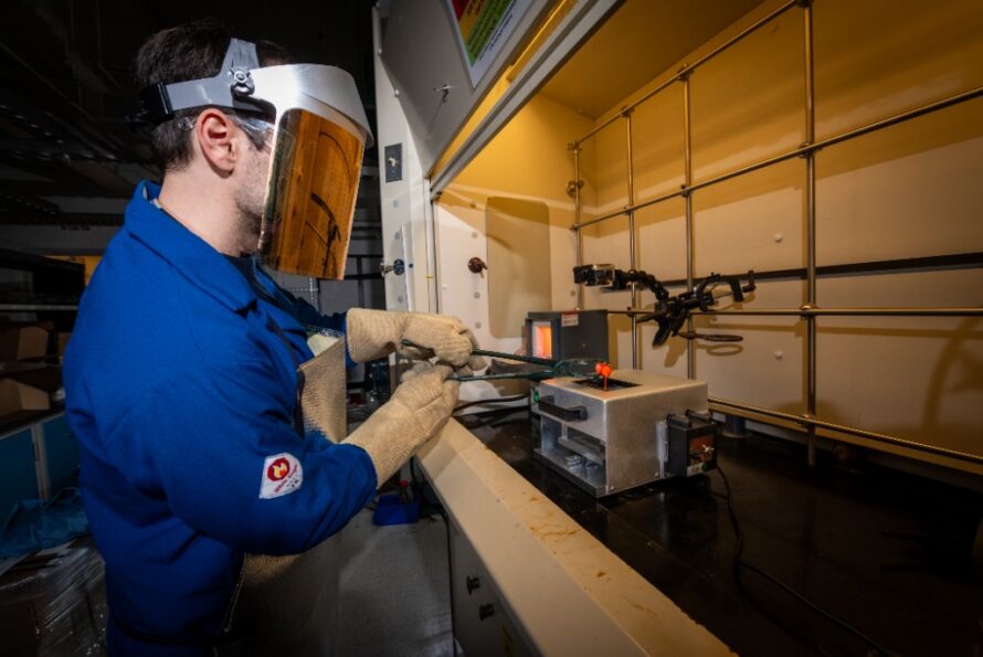 Andrew Dopilka, a research scientist in Berkeley Lab’s Energy Technology Area, pours molten material into the twin roller quencher, a device custom-made for his research by the Engineering Small Projects Support Group. The device quickly cools the material, leading to the creation of amorphous solids that will be used to help advance battery technology. (Credit: Thor Swift, Berkeley Lab)