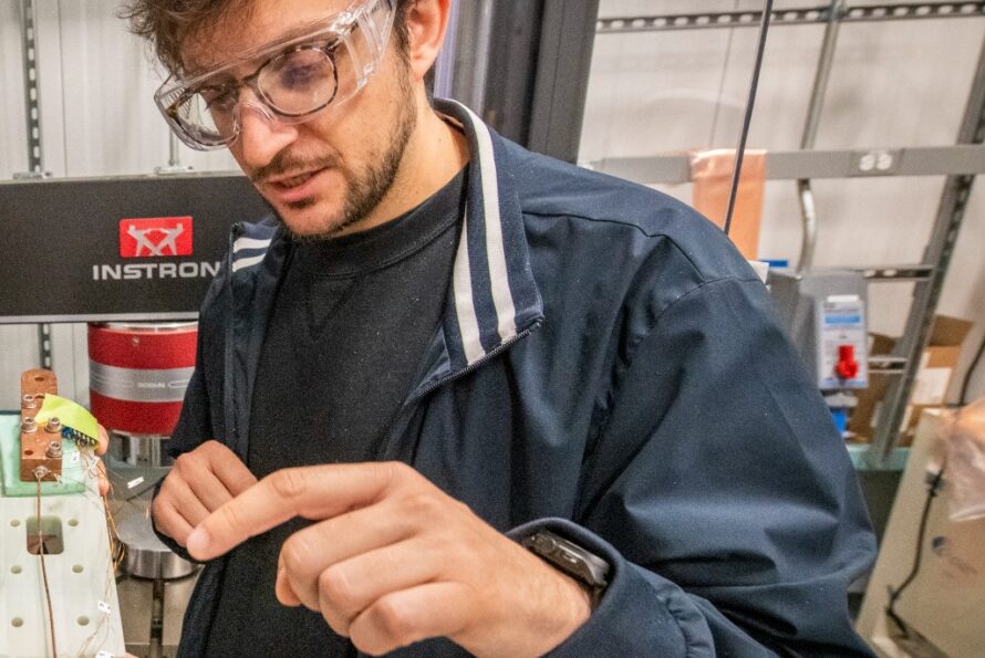 Giorgio Vallone, a research scientist in Berkeley Lab’s Engineering Division, examines part of a superconducting magnet. (Credit: Robinson Kuntz, Berkeley Lab)