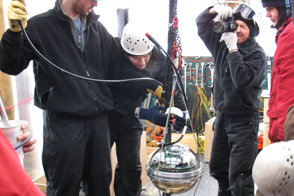 An IceCube digital optical module attached to it’s cable, ready to be lowered 2.4 kilometers into its final location in the South Polar icecap. The sensor electronics were designed and built at Berkeley Lab. Photographer: Spencer Klein, Berkeley Lab